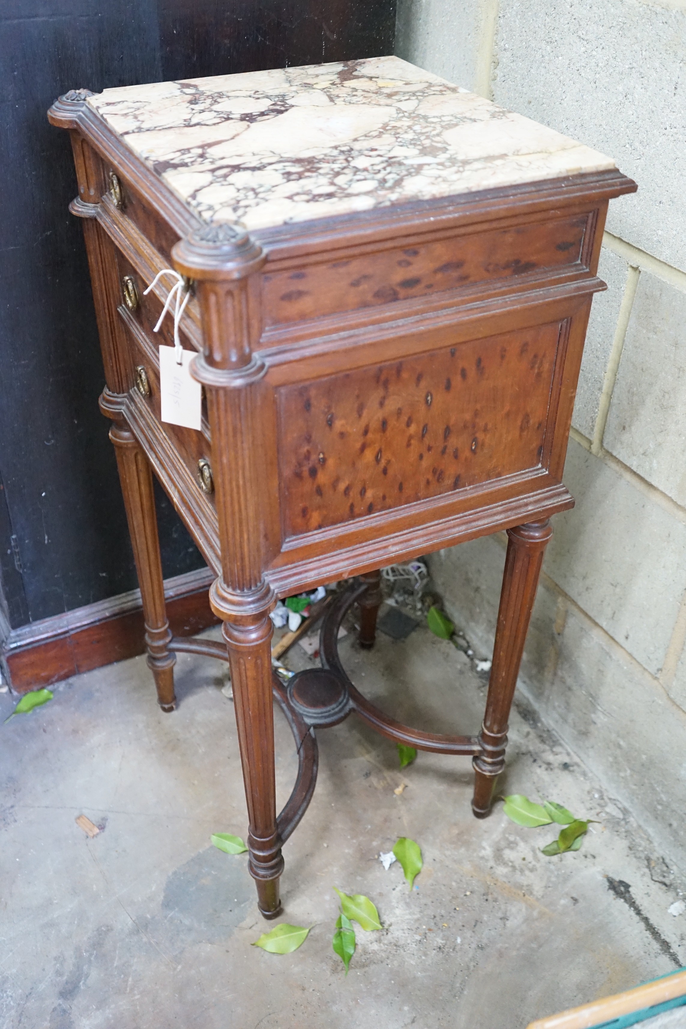 An early 20th century French marble topped mahogany bedside cabinet, fitted with a single drawer above a pot cupboard disguised as two drawers, 84 cm high, 42 cm wide 37 cm deep